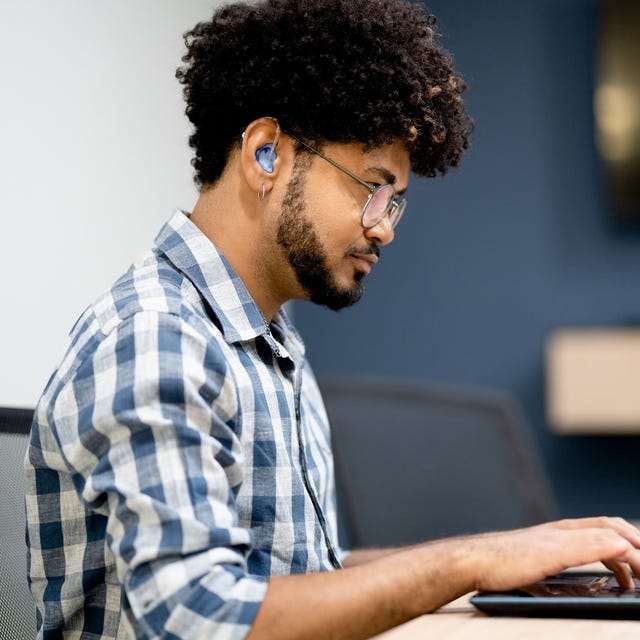 hearing impaired man working on laptop at office