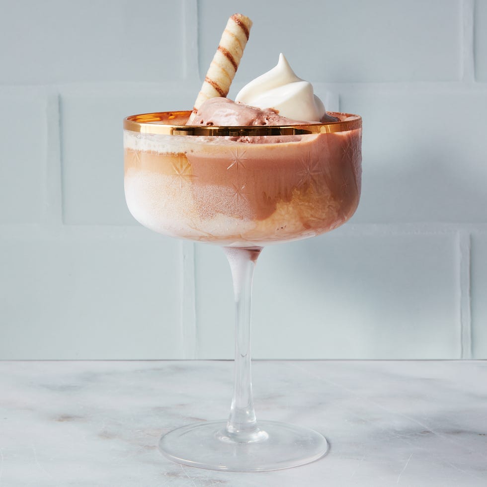 dessert in a glass with multiple layers and a decorative wafer