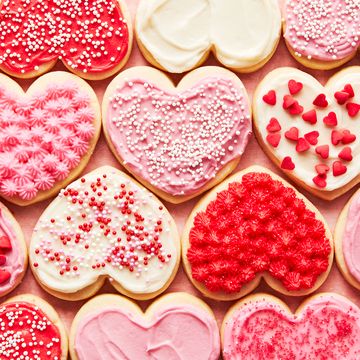 heart shaped sugar cookies iced with red, white, and pink frosting and sprinkles