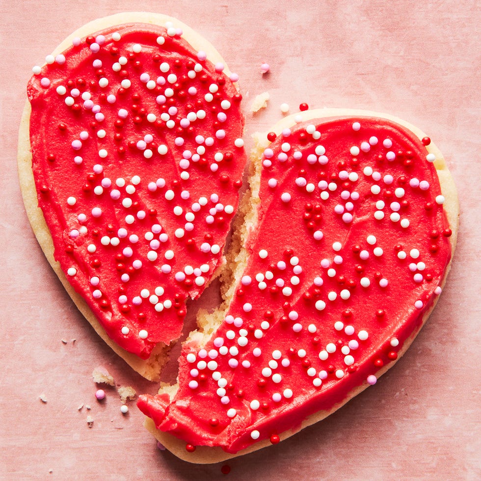 heart shaped sugar cookies iced with red, white, and pink frosting and sprinkles
