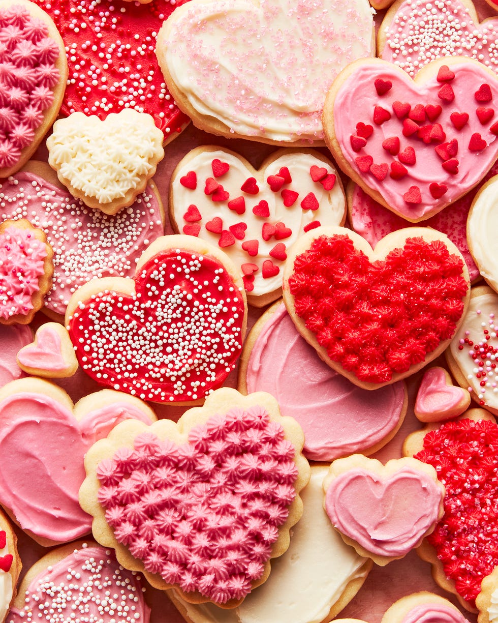 heart shaped sugar cookies iced with red, white, and pink frosting and sprinkles