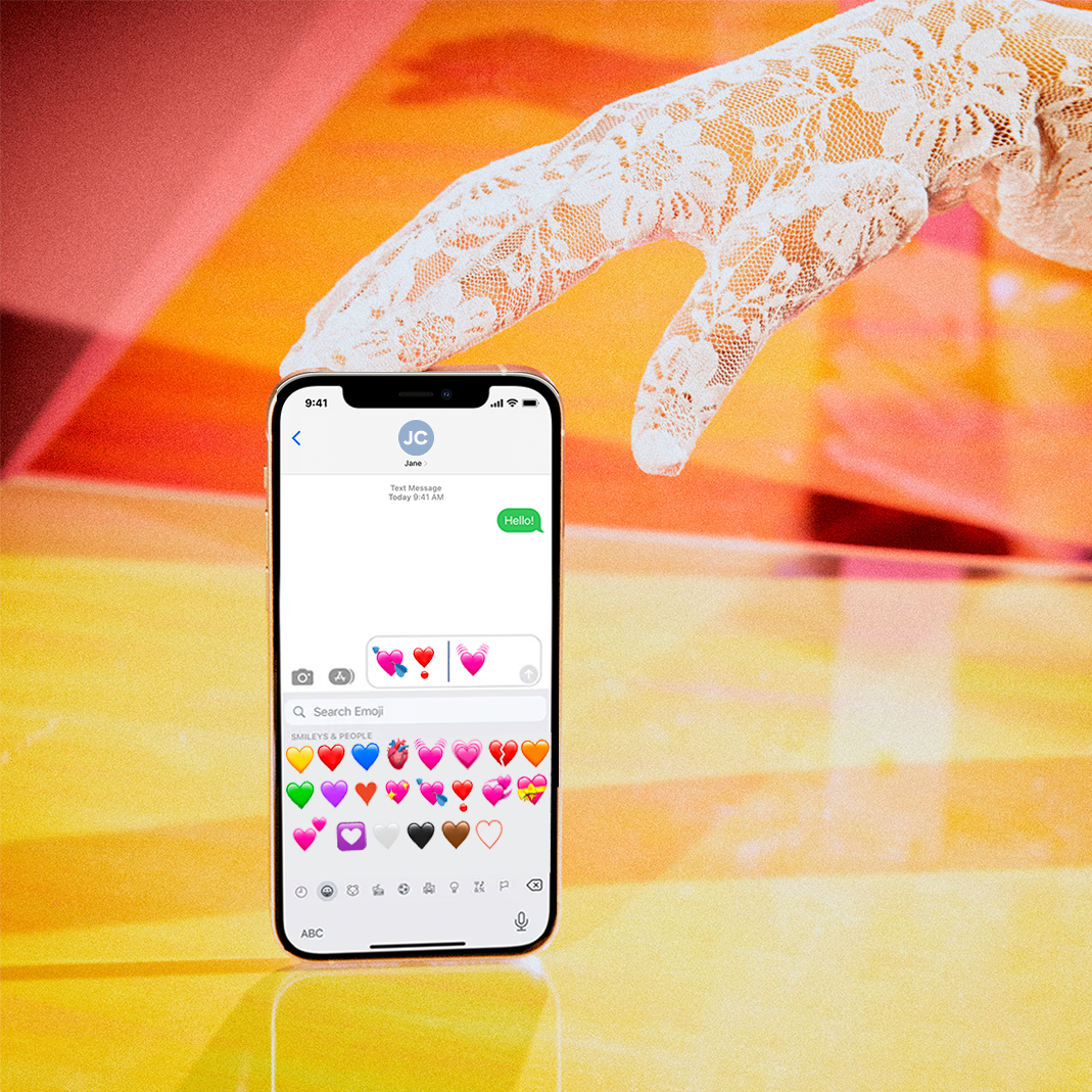 a white lace gloved hand holds a phone with imessage displayed on the screen