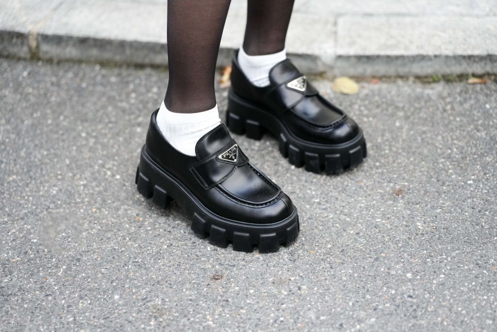 a model wears a pair of prada chunky loafers in a roundup of the best loafers 2023