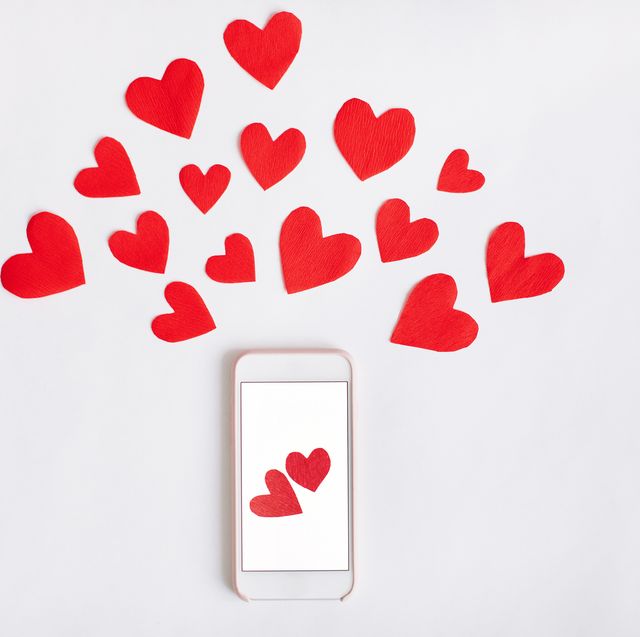 Heart Shape Papers And Mobile Phone Against White Background