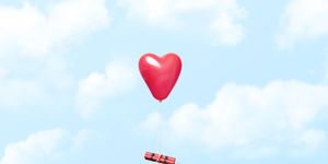 heart shaped balloon carrying a dynamite stick