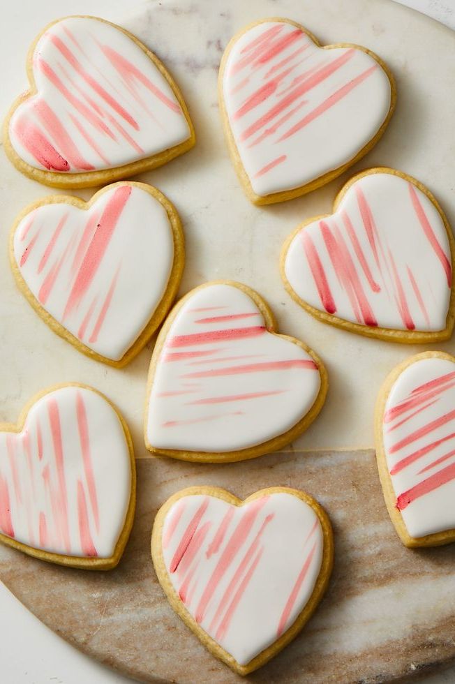 pink and white heart shaped cookies on marble surface