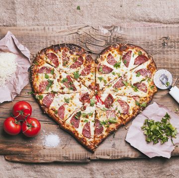 heart shaped foods   heart shaped pizza and ingredients on cutting board