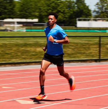 a person running Oliv on a track