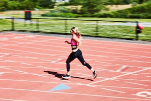 a woman running on a track