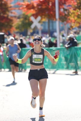 runner participating in a marathon crossing the finish line