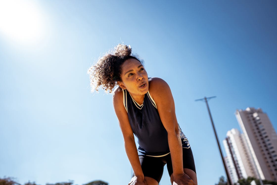 mid adult woman looking away during exercises outdoors