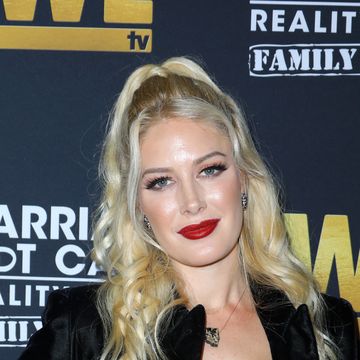 heidi montag with blond hair in high pony, wearing black blazer and blue jeans