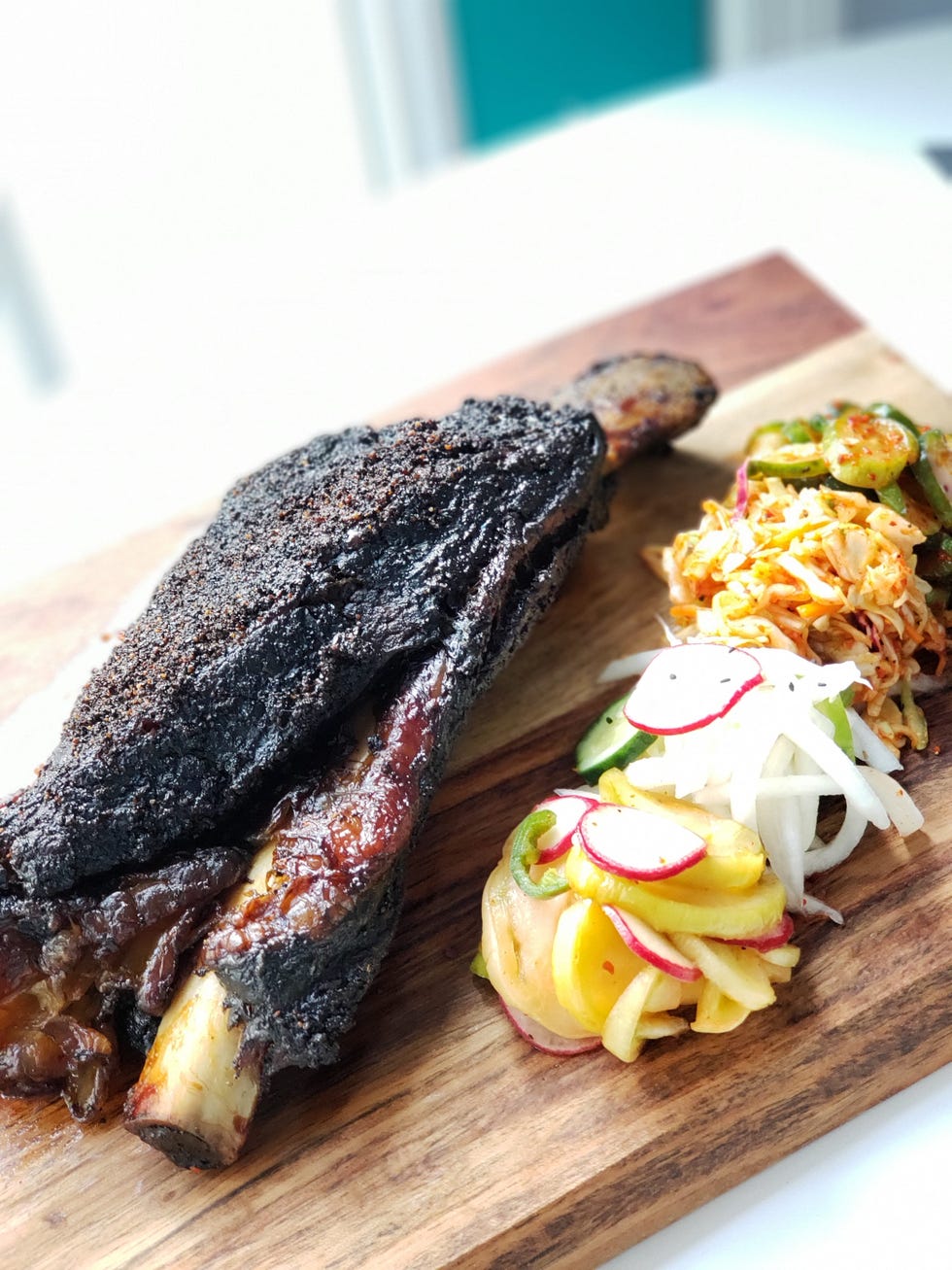 grilled meat served with side dishes on a wooden platter