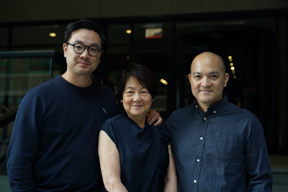lo and sons, a mother and her two older sons beside her
