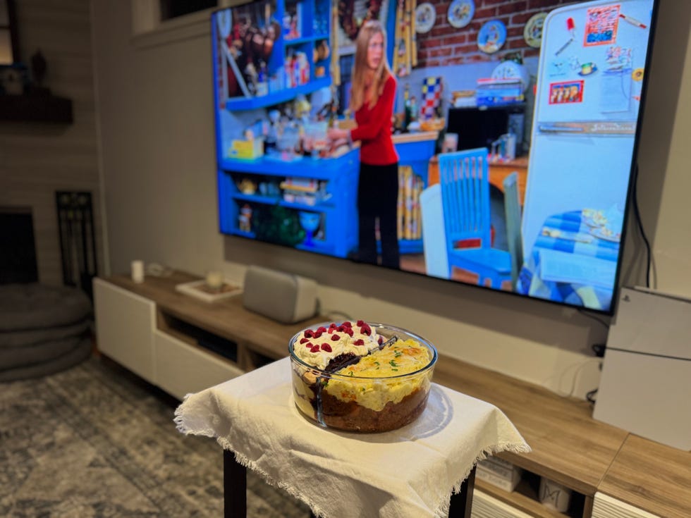 dessert placed on a table in a living room with a tv showing a kitchen scene
