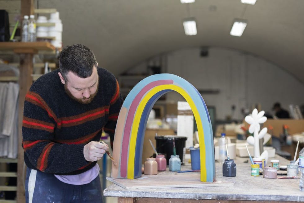 John Booth hand painting ceramic rainbow