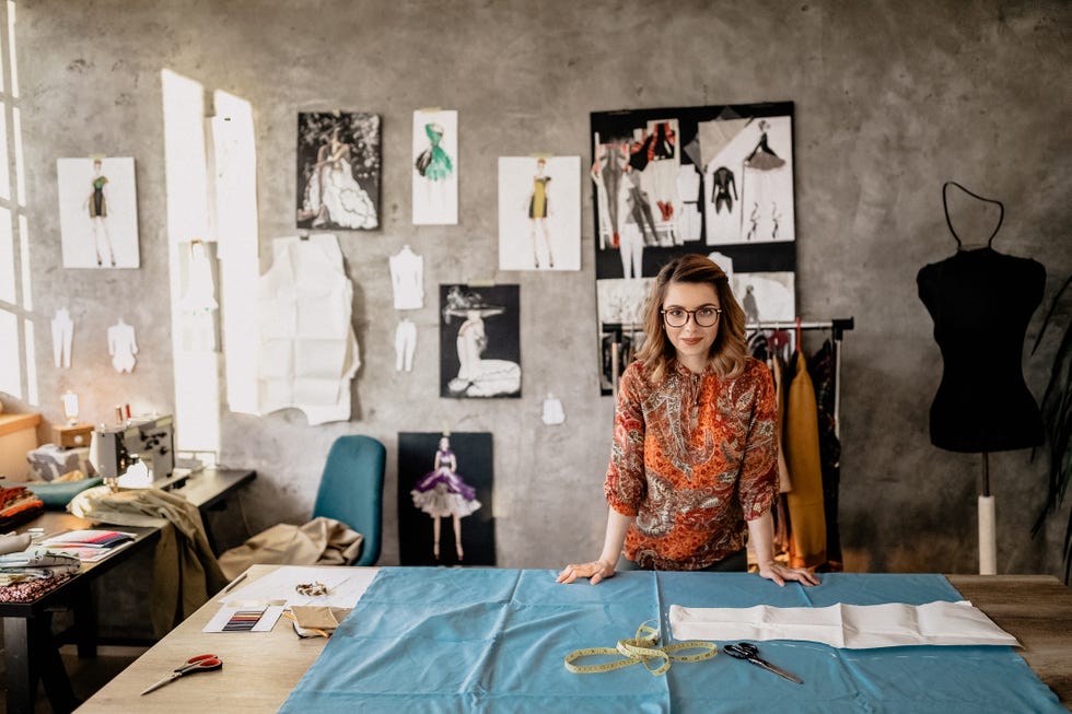 jobs for stay at home moms - woman in a fashion design room with fabric and sketches