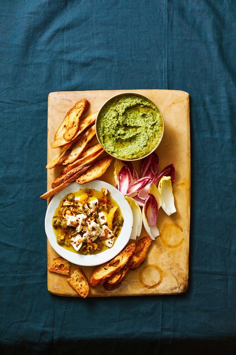 green herbed white bean dip with crostini and vegetables