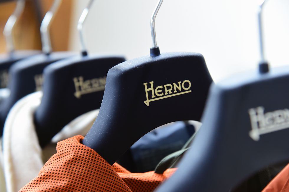 novara, italy may 18 a logo of herno is displayed at the herno factory during the visit within the apritimoda initiative at herno on may 18, 2019 in novara, italy photo by pier marco taccagetty images