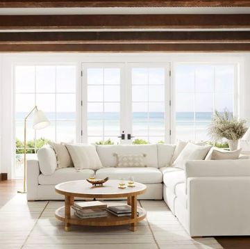 a living room with a white couch and a fireplace