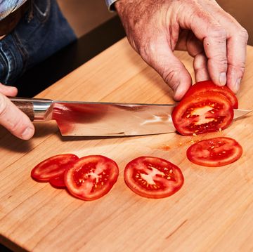 slicing tomatoes on a maple cutting board