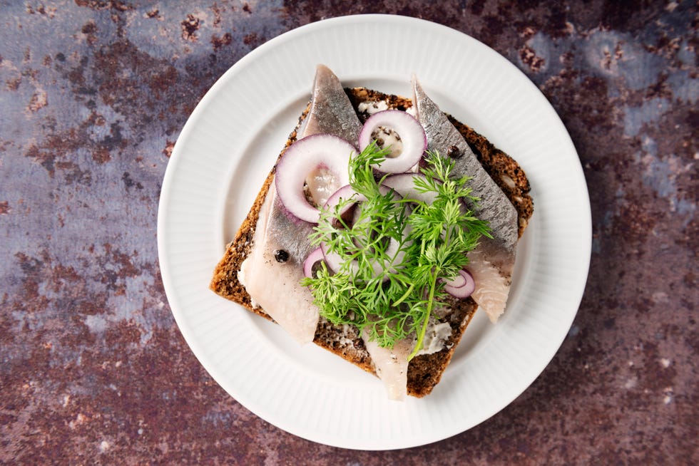 marinated herring with onion and dill on bread