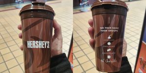 brown travel mug that says hersheys on the front and that the foud basic food groups are chocolate and hot chocolate