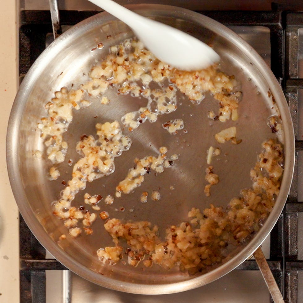 onions getting cooked in a large skillet