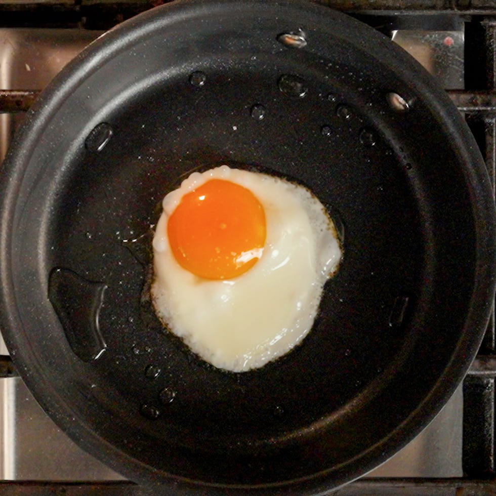 cooking an egg in a skillet
