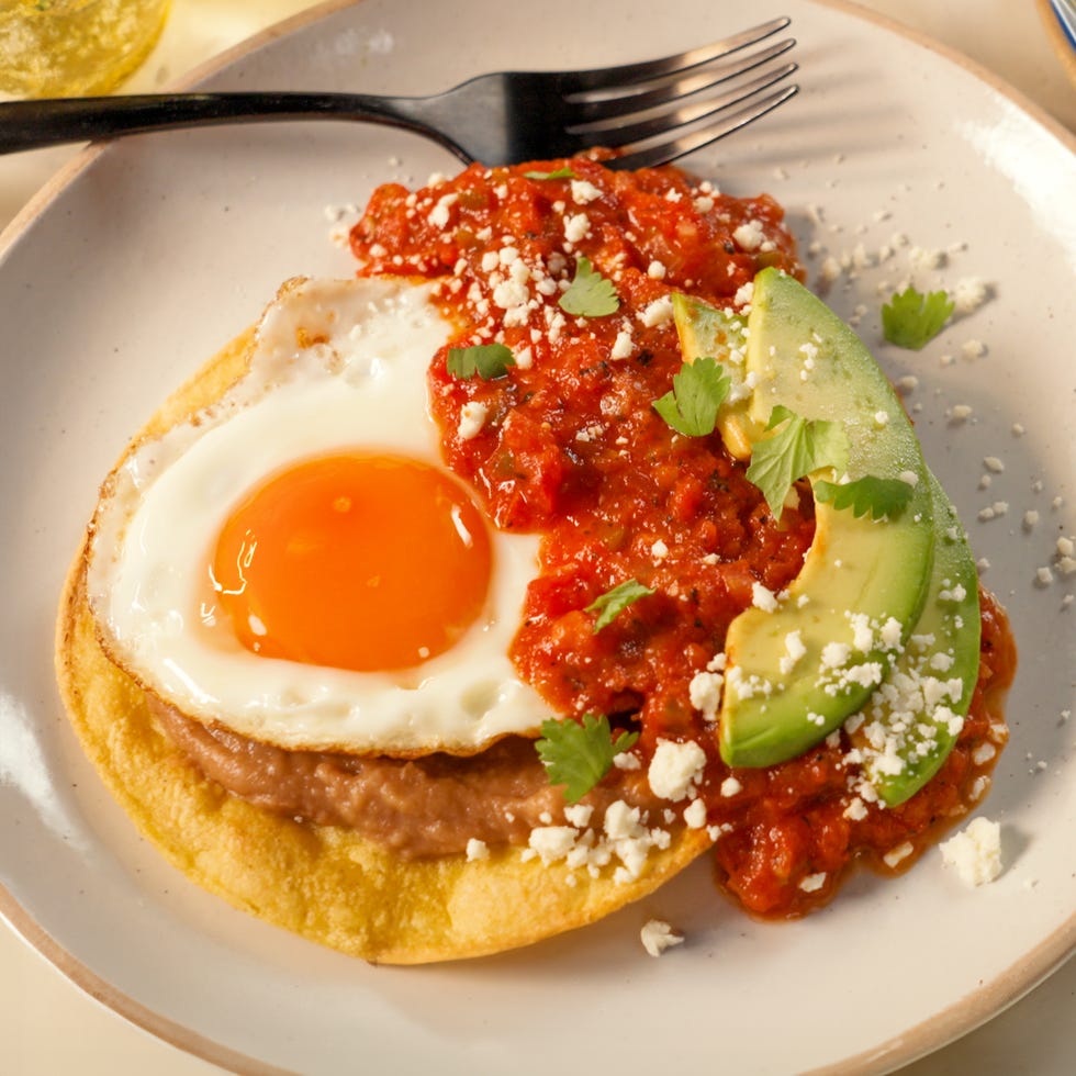 huevos rancheros on a plate with a fork
