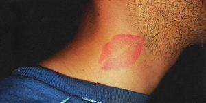man's neck with lipstick kiss mark on it