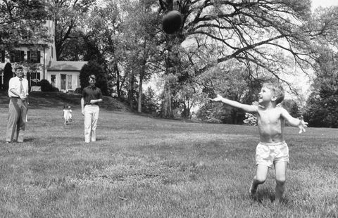 sen john kennedy l throwing football to his nephew bobby jr as his bro robert looks on, in his yard at hickory hill home