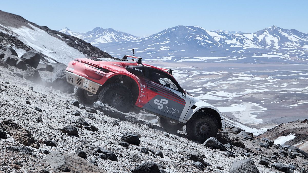 lifted porsche 911 prototype driving on the side of a volcano