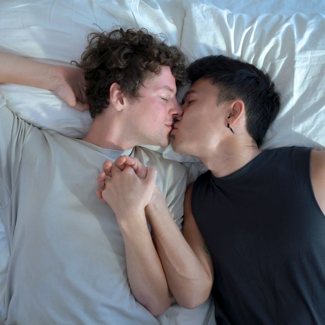 gay couple kissing in bed