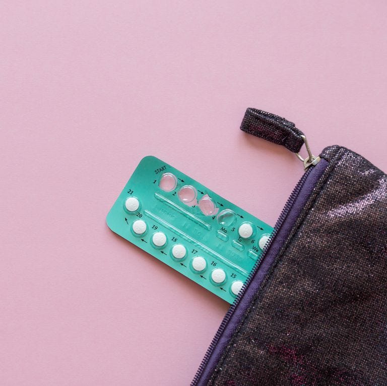 High Angle View Contraceptive Pill And Purse Over Pink Background