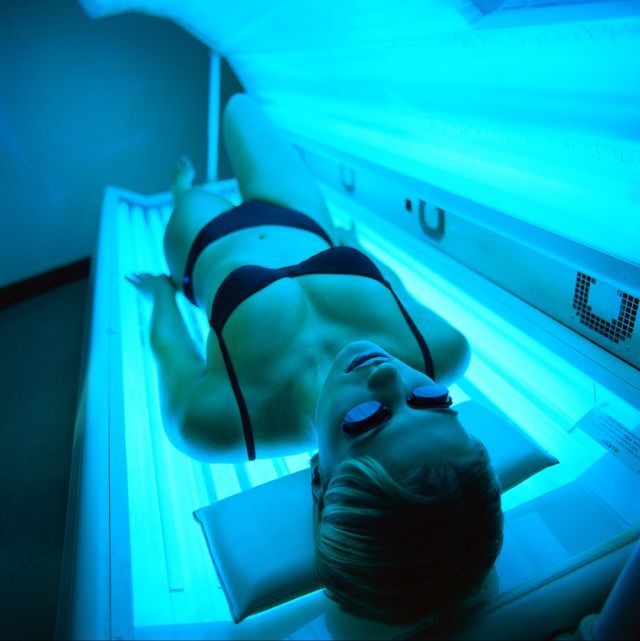 high angle view of a woman lying in a tanning machine
