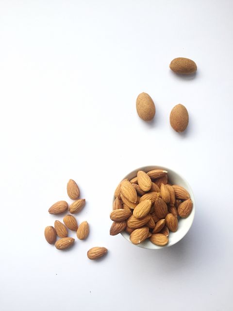 high angle view of almonds in bowl against white background