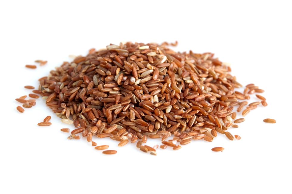 high angle view of brown rice on white background