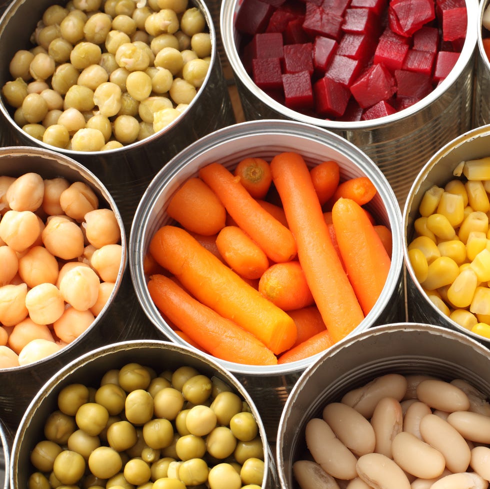 High angle view of cans filled with vegetables High angle view of cans filled with vegetables