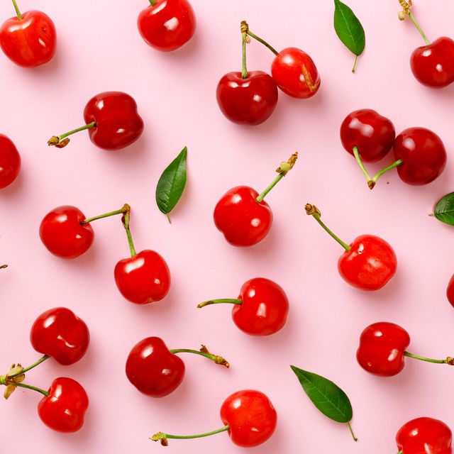 High Angle View Of Cherries On Pink Table
