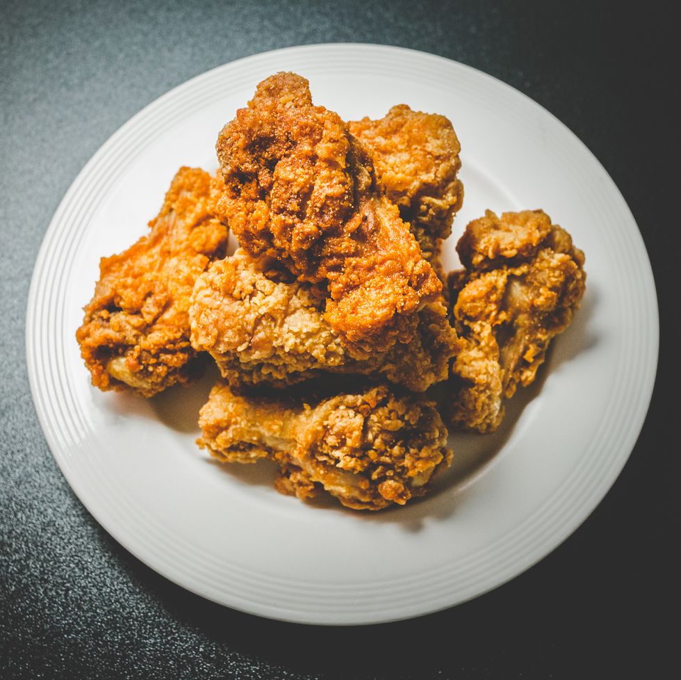 High Angle View Of Chicken Wings In Plate Over Black Background