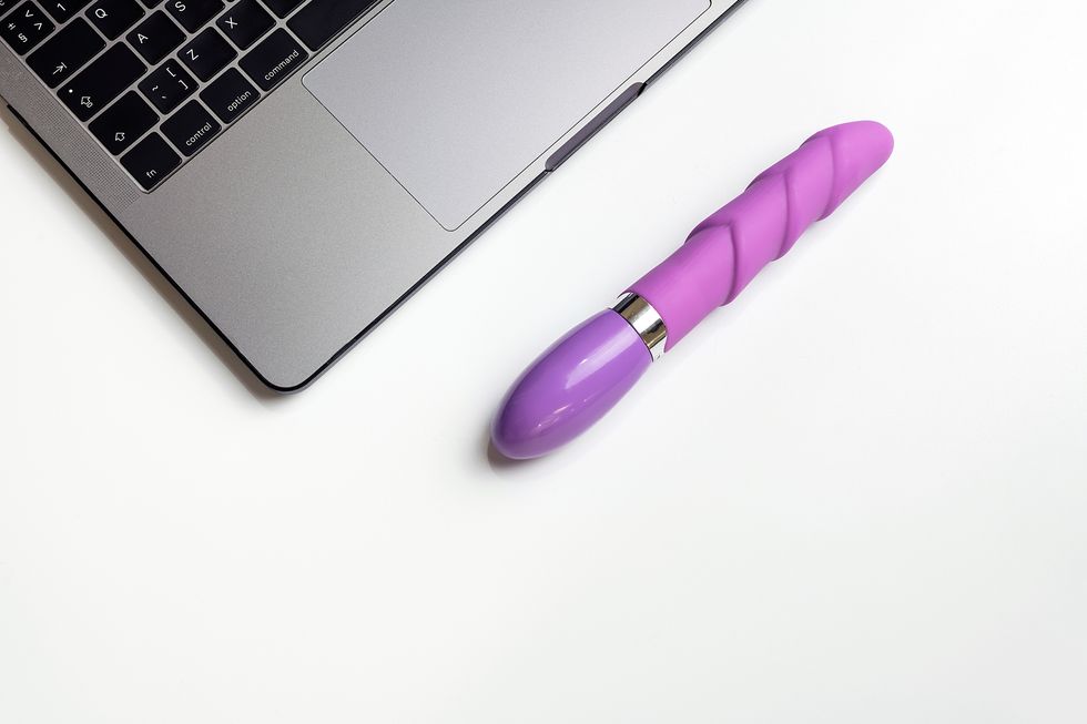 high angle view of dildo by laptop on table