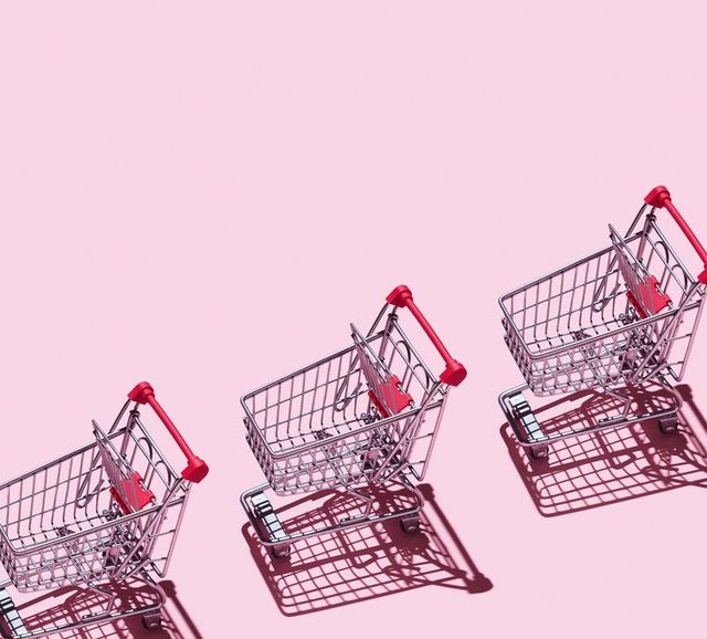 High Angle View Of Empty Shopping Carts Arranged On Pink Background