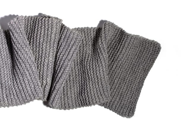 high angle view of gray woolen scarf on white background