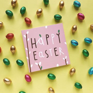 high angle view of greeting card with easter eggs on yellow background