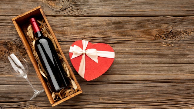 https://hips.hearstapps.com/hmg-prod/images/high-angle-view-of-heart-shaped-gift-box-with-wine-royalty-free-image-1610660282.?crop=0.563xw:1.00xh;0.0288xw,0.00284xh&resize=640:*