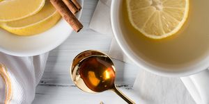 high angle view of honey with lemons on table