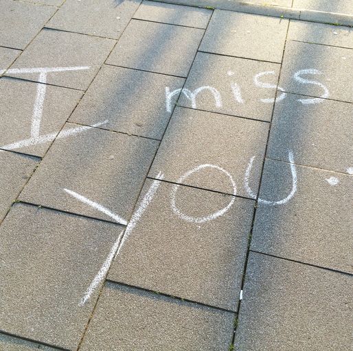 high angle view of i miss you text on footpath