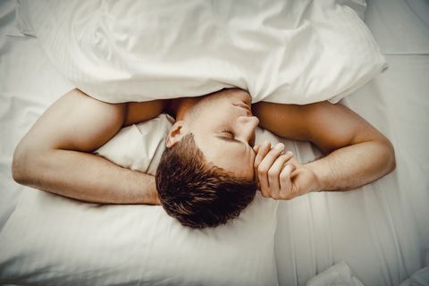 High Angle View Of Man Sleeping On Bed At Home