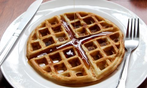 High Angle View Of Maple Syrup Falling On Waffle In Plate